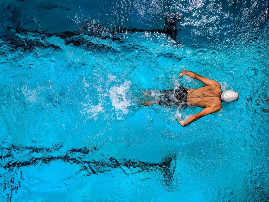 Woman swimming in clear blue ocean water